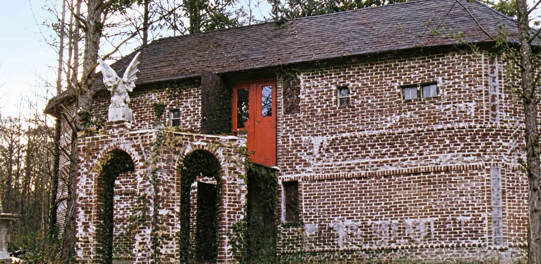 The brick house at Corpsewood with its arched gazebo in front.
